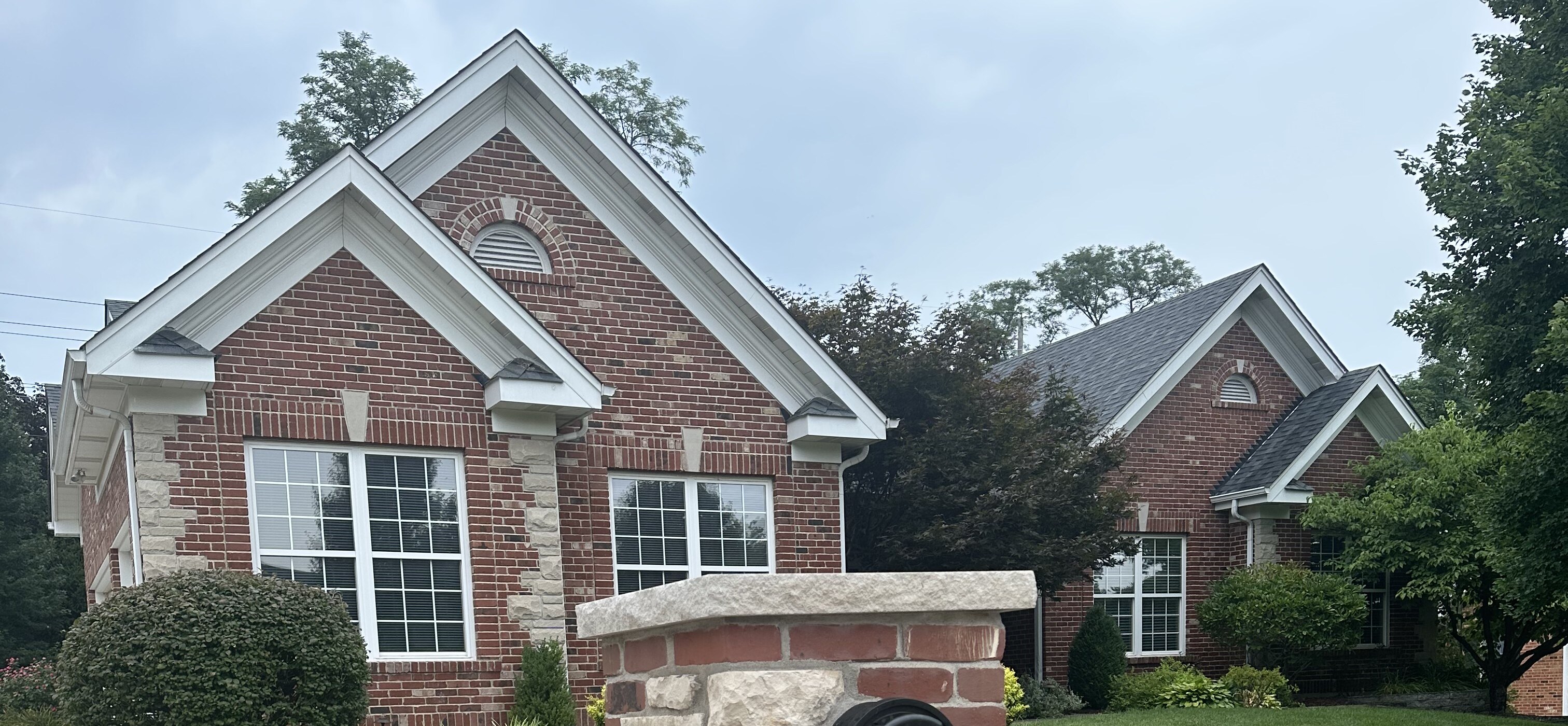 Finished red brick home with limestone masonry accents