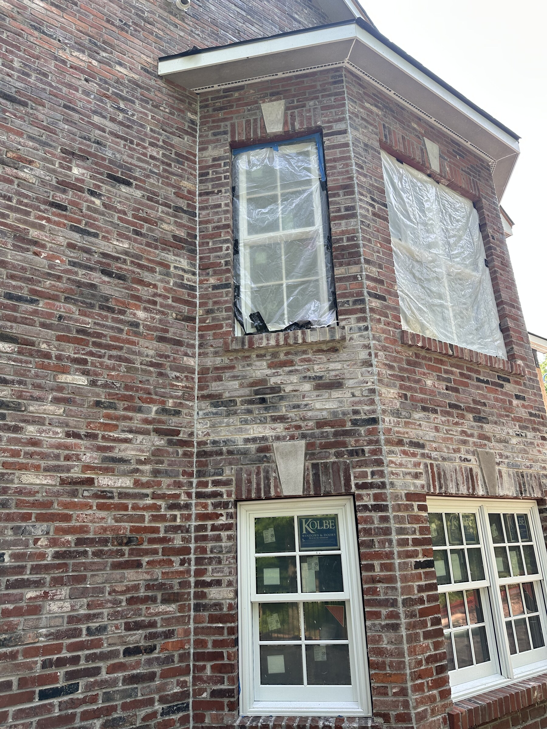 Historic brick bay restoration and window masonry