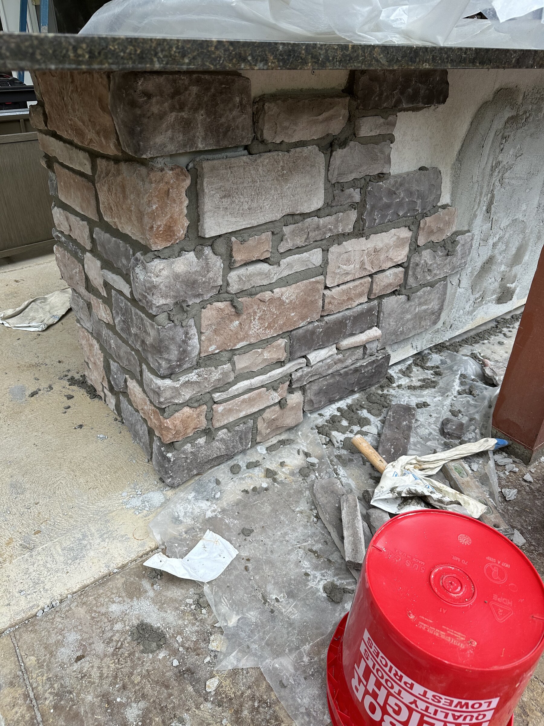 Stone fireplace masonry detail during construction