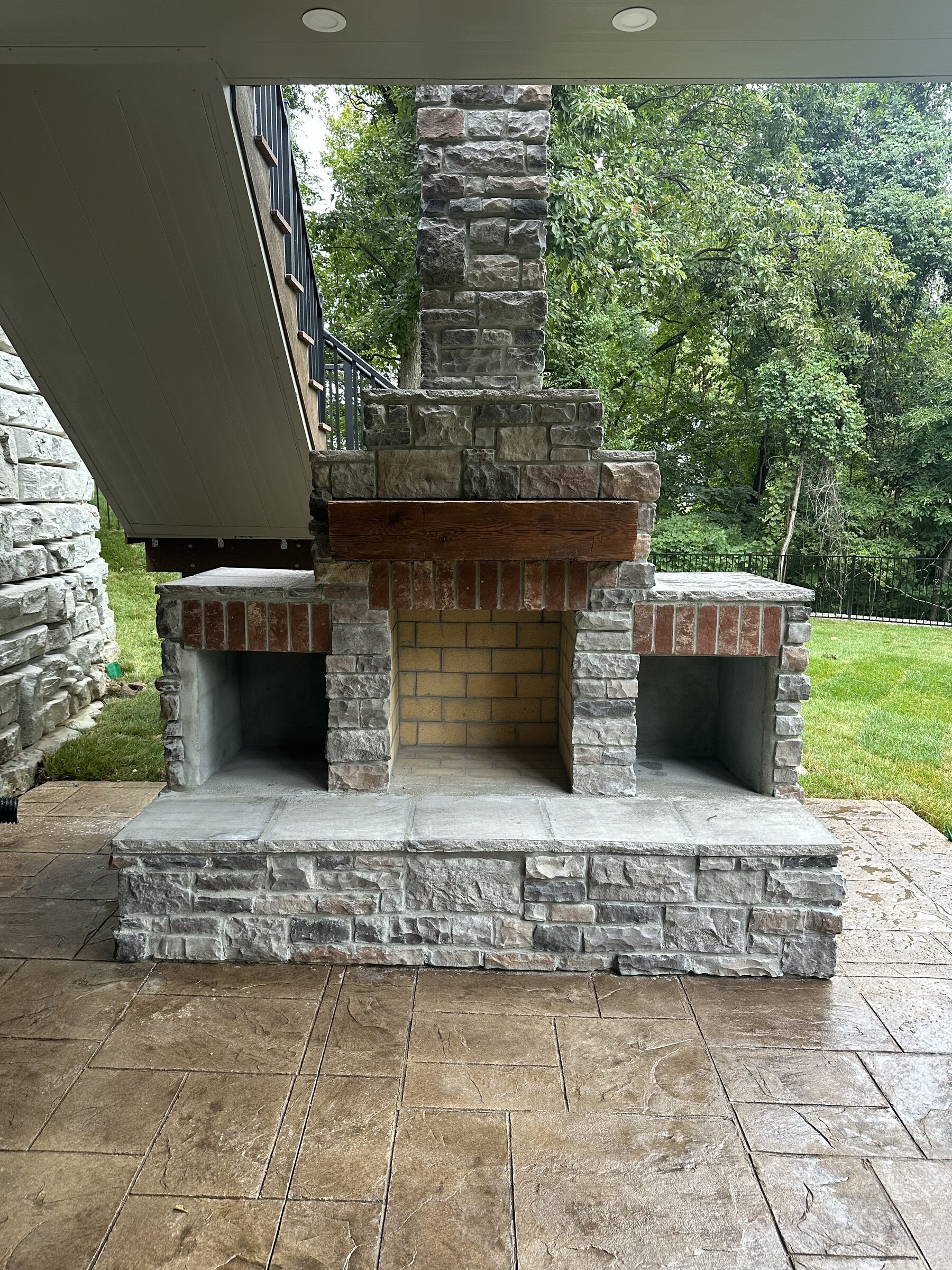 Custom outdoor stone masonry fireplace