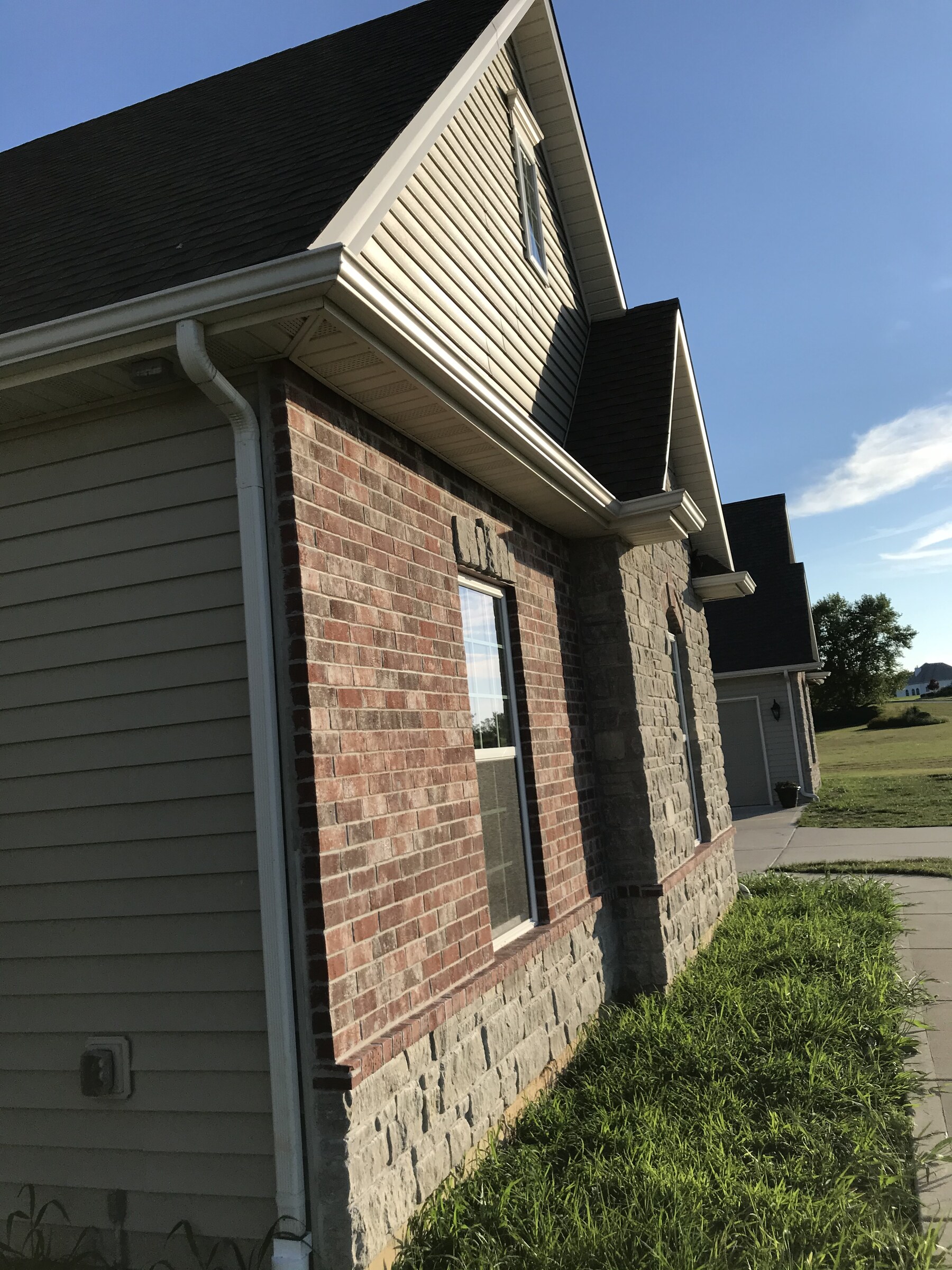 Residential natural stone veneer and brick exterior