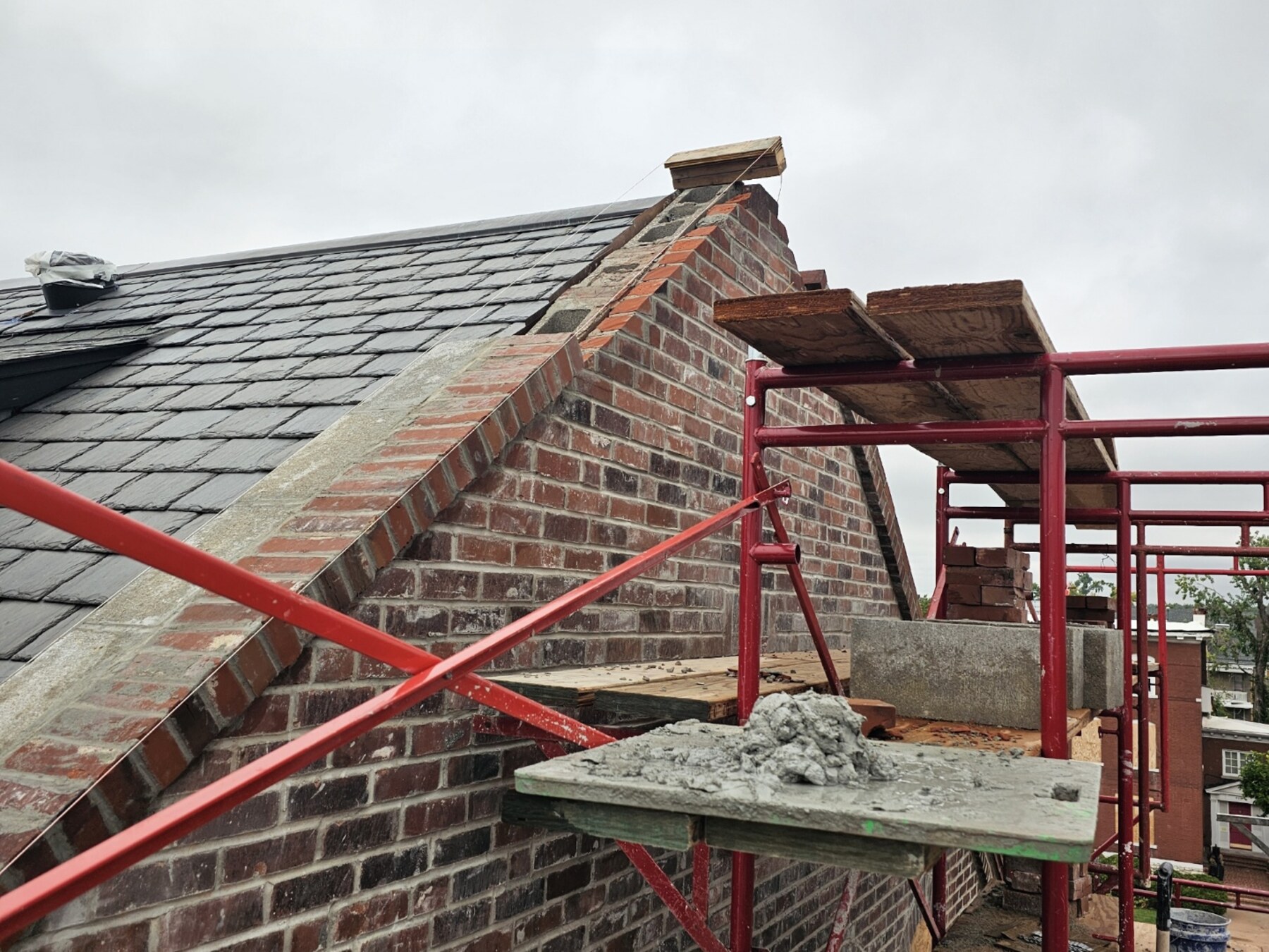 Minnella Masonry brick restoration and mortar work on scaffolding